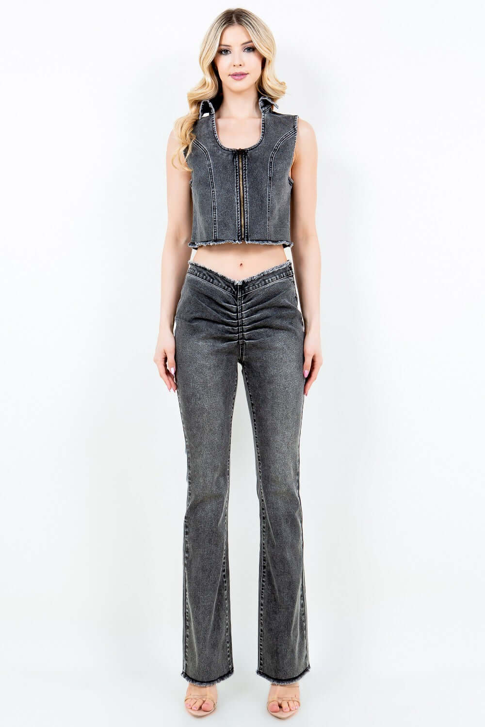 Woman wearing American Bazi V-Cut Ruched Flare Pants with side zipper closure, slim fit, natural cut hem, and matching crop top.