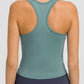 Back view of a woman wearing a Millennia Round Neck Racerback Active Tank in green for ultimate comfort and flexibility.