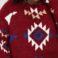 Woman wearing a HEYSON full size Aztec fuzzy sweater with vibrant red, blue, and beige pattern, showcasing cozy and artistic design.