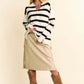 Model showcasing Davi & Dani high-low striped Johnny collar sweater paired with a chic skirt and stylish boots.