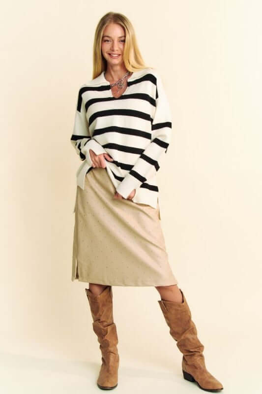 Model showcasing Davi & Dani high-low striped Johnny collar sweater paired with a chic skirt and stylish boots.