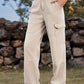 Woman wearing Bella Road High Waist Cargo Straight Jeans in beige with pockets, standing outdoors.