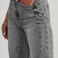 Woman wearing Bella Road Raw Hem Wide Leg Jeans with Pockets in grey, showing front button and pocket detail.