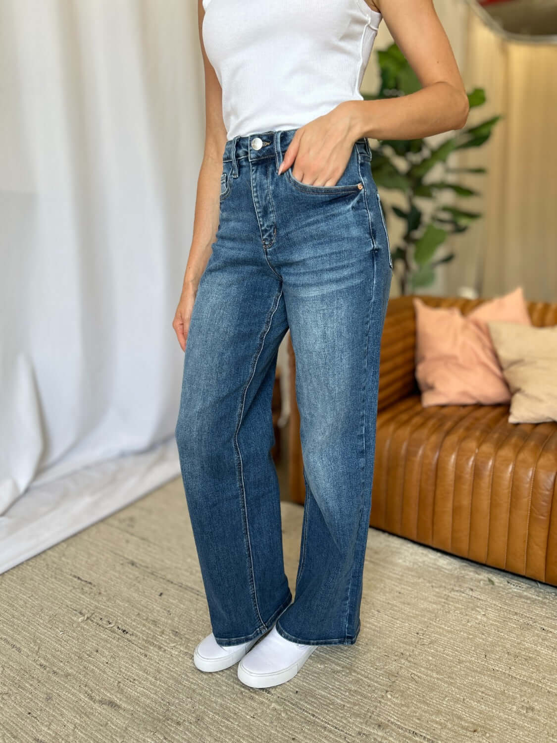 Woman wearing RFM Full Size High Rise Tummy Control Wide Leg Jeans in a casual setting