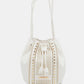 Nicole Lee USA Amy Studded Bucket Bag in white vegan leather with stud and zipper detailing, drawstring closure, and metal feet.