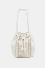 Nicole Lee USA Amy Studded Bucket Bag in white vegan leather with stud and zipper detailing, drawstring closure, and metal feet.