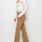 Model in Risen Jeans Bailey High Waist Side Slit Flare Jeans with tan color, showcasing flattering high-rise waist and side slit detailing