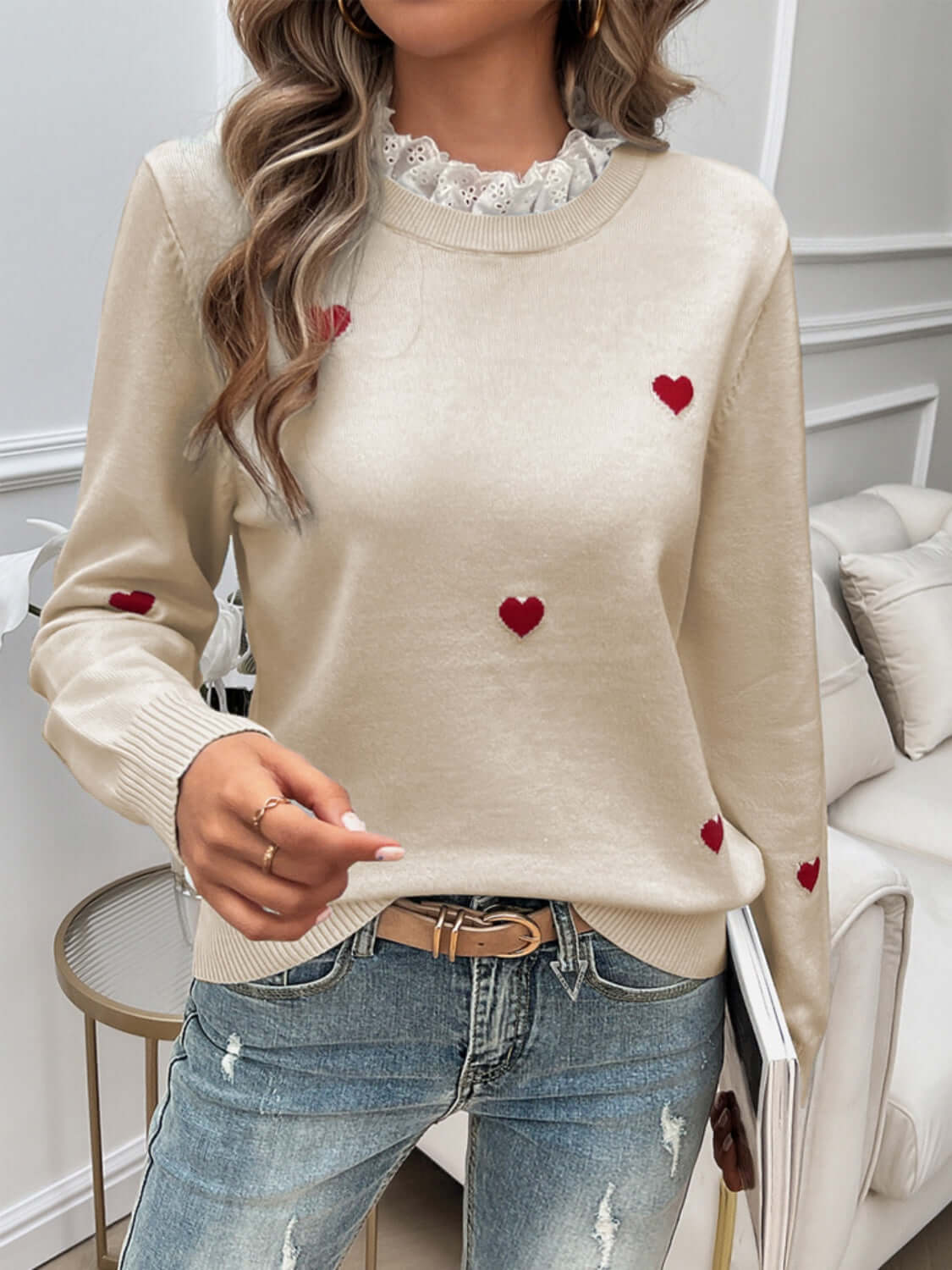 Woman wearing Devine Lace Detail Heart Long Sleeve Sweater with red heart details and lace neckline, paired with blue jeans.