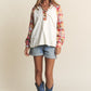 Woman wearing J.NNA Plaid Contrast Button Down Henley Top with denim shorts and cowboy boots, showcasing a chic casual style.