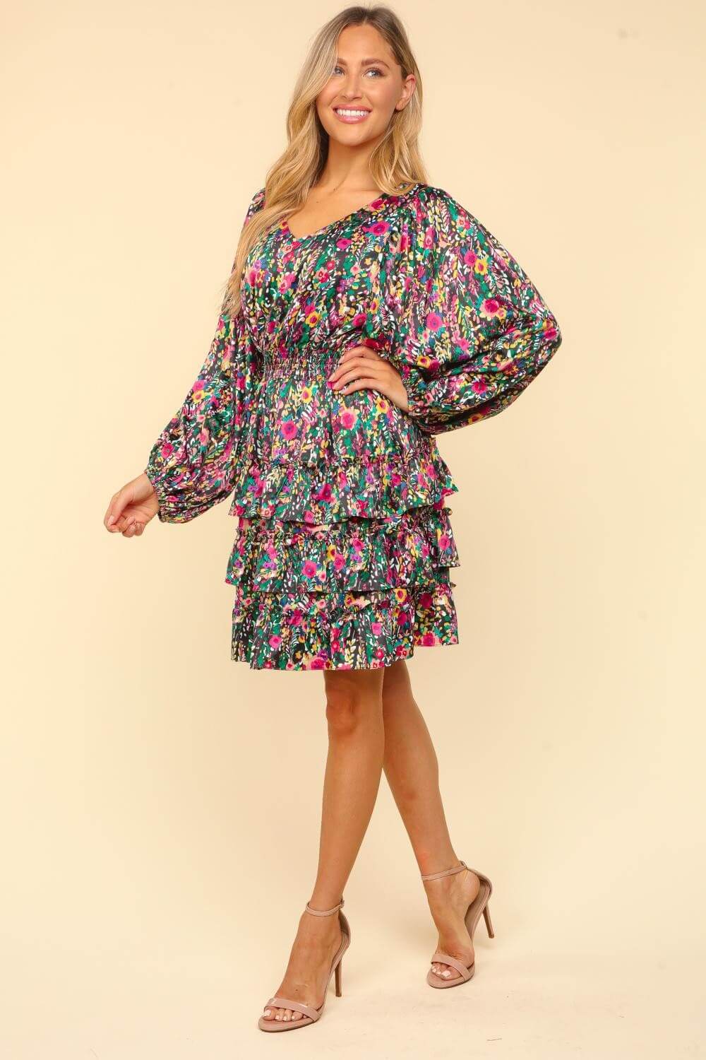 Woman wearing a Haptics V-Neck Satin Floral Layered Dress with flowy sleeves and vibrant floral print, perfect for elegant events.