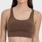 Stylish crisscross scoop neck active tank in rich brown, perfect for workouts and staying active with comfort.