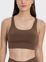 Stylish crisscross scoop neck active tank in rich brown, perfect for workouts and staying active with comfort.