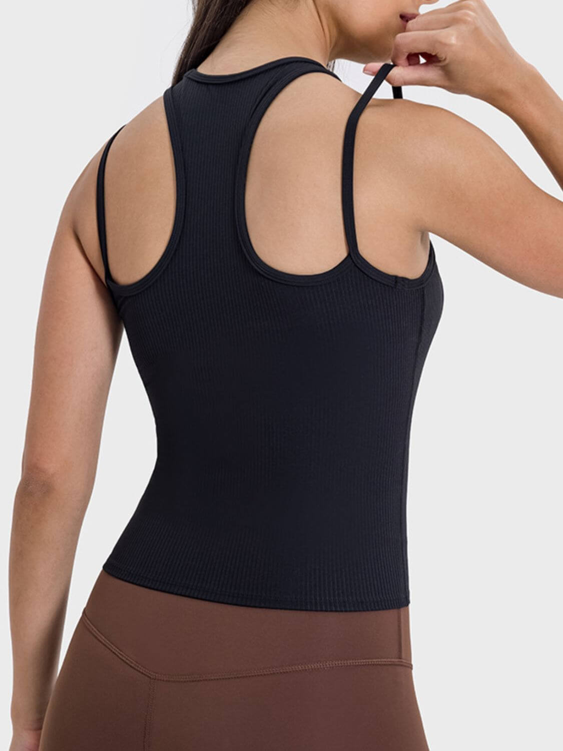 Sleek black racerback tank top showing unique cutout design and comfy fit, perfect for dynamic workouts and stylish activewear.