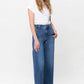 Stylish woman wearing Judy Blue Full Size Double Button Wide Leg Jeans with a high rise design, showcasing fashionable comfort.