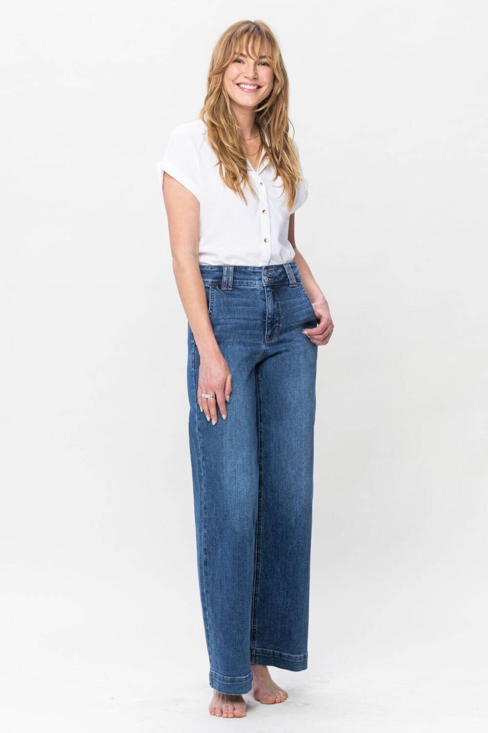 Stylish woman wearing Judy Blue Full Size Double Button Wide Leg Jeans with a high rise design, showcasing fashionable comfort.