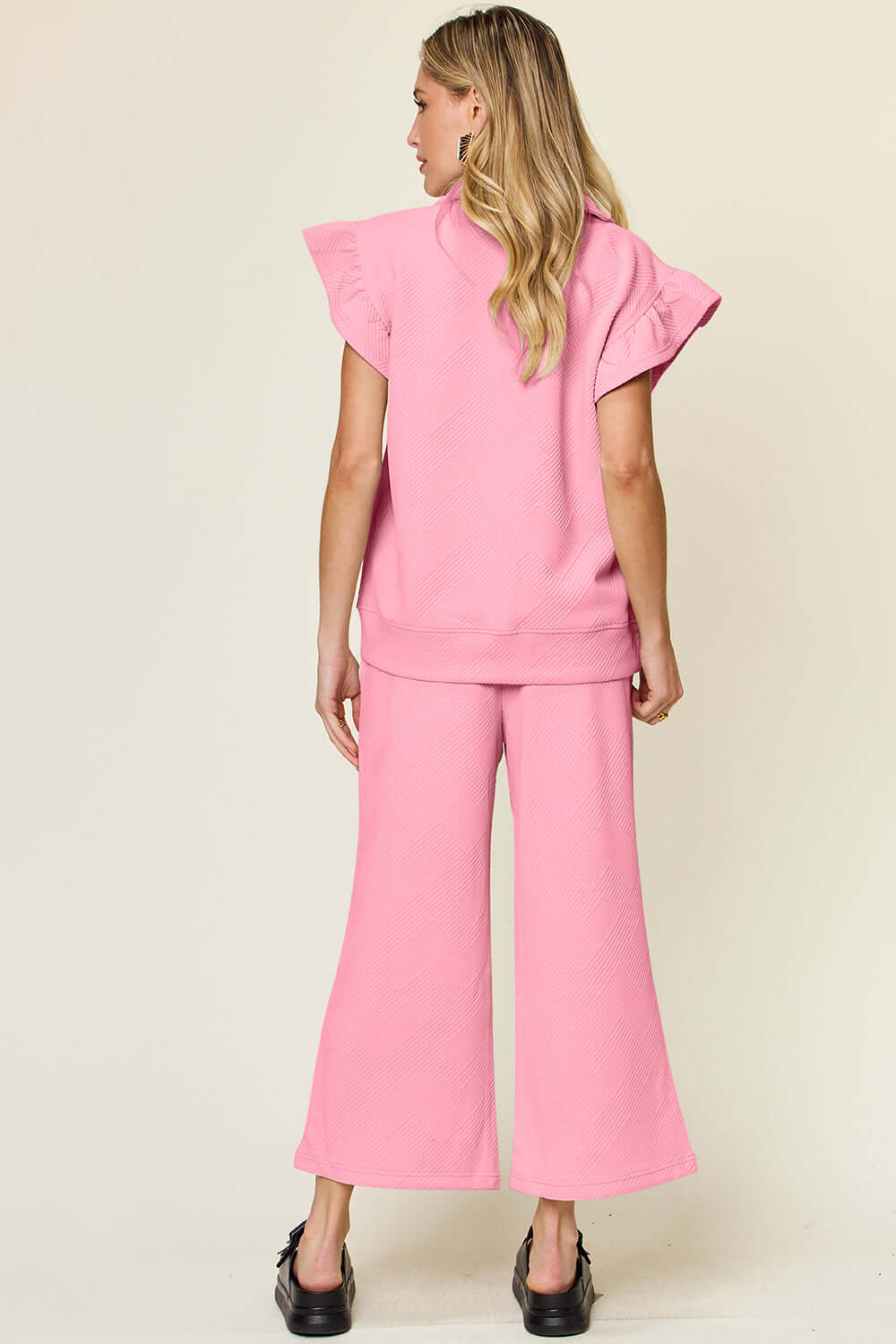 Woman wearing pink Texture Ruffle Short Sleeve Top and Drawstring Wide Leg Pants Set, showing back design.