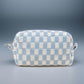 Stylish blue checkered knitted cosmetic pouch with zipper closure, perfect for organizing makeup essentials.