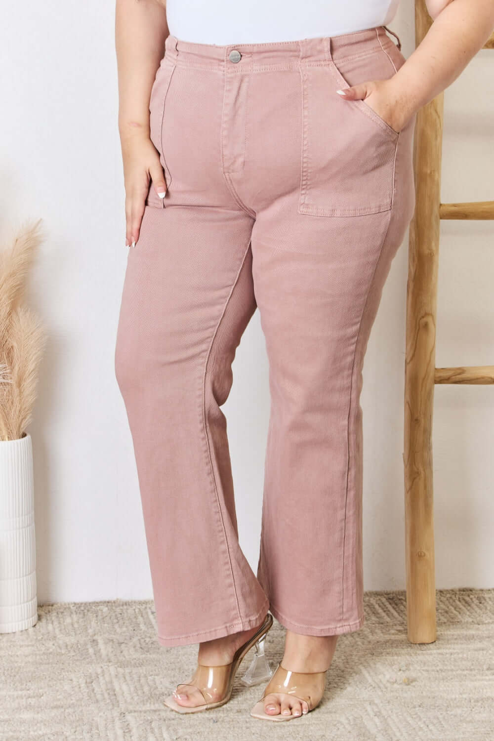 High Rise Ankle Flare Jeans in pink, featuring a pocketed design and slightly stretchy material. Perfect for a flattering silhouette. Risen Jeans.