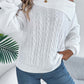 Woman wearing Bella Road cable-knit one shoulder long sleeve sweater in white, styled with jeans, showcasing casual yet stylish outfit.