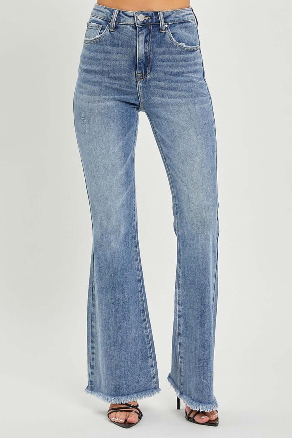 RISEN high waist raw hem flare jeans on a model showcasing trendy retro-inspired fashion with a flattering fit for comfort and style.