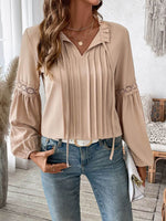 Woman wearing Perfee Frill Tie Neck Long Sleeve Blouse with delicate ruffled details and tie neck design, paired with jeans and accessories.