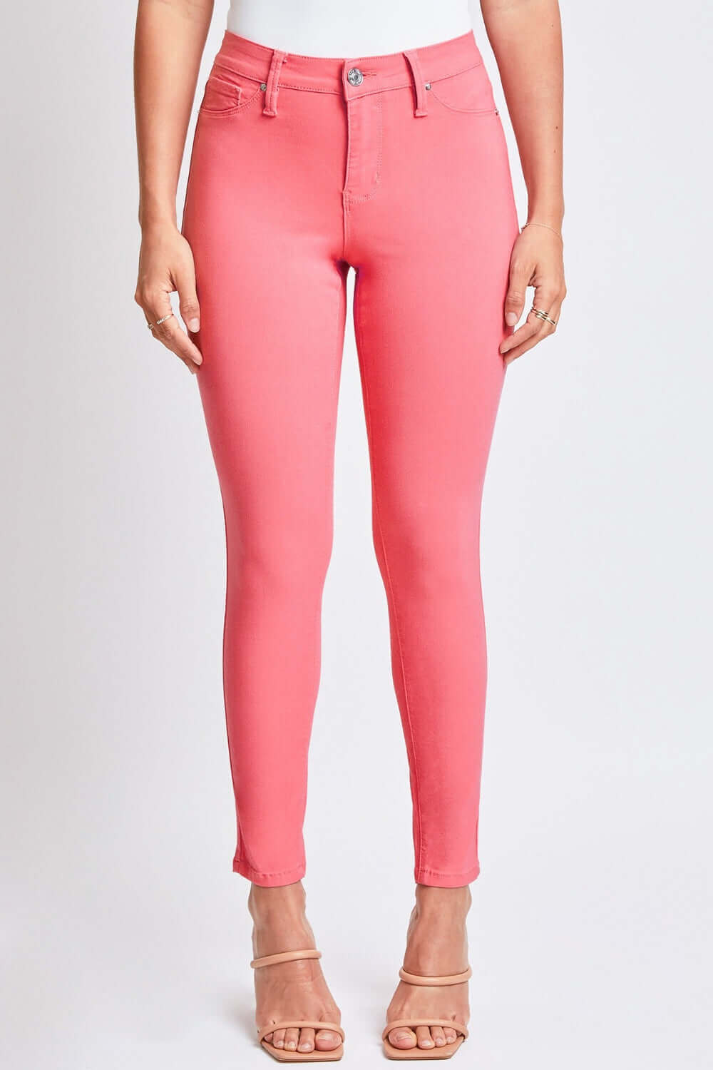 Hyperstretch Mid-Rise Skinny Jeans in vibrant pink by YMI Jeans, featuring a comfortable and flattering fit with stretchy fabric and chic style.