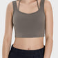 Stylish woman wearing a crisscross square neck active tank, perfect for workouts and casual errands.