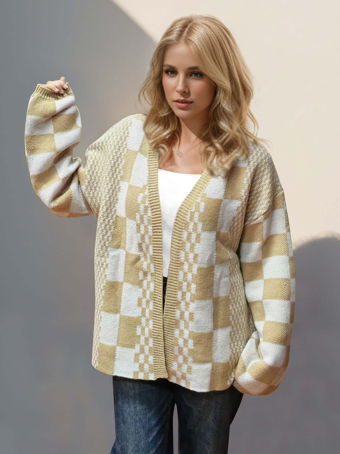 Woman wearing a tan Double Take Checkered Cardigan with open front and dropped shoulders, styled casually with jeans.