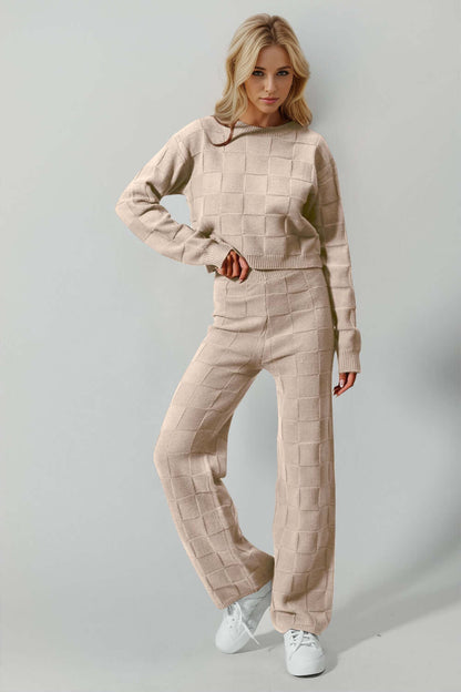 Model wearing Double Take Checkered Round Neck Top and Pants Set in beige, showcasing stylish leisurewear with an edgy twist.