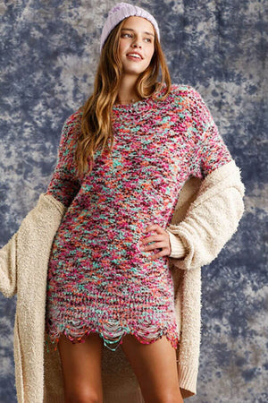 Model wearing a multicolored distressed hem tunic dress with a cozy cardigan and beanie, perfect for trendy casual outfits.
