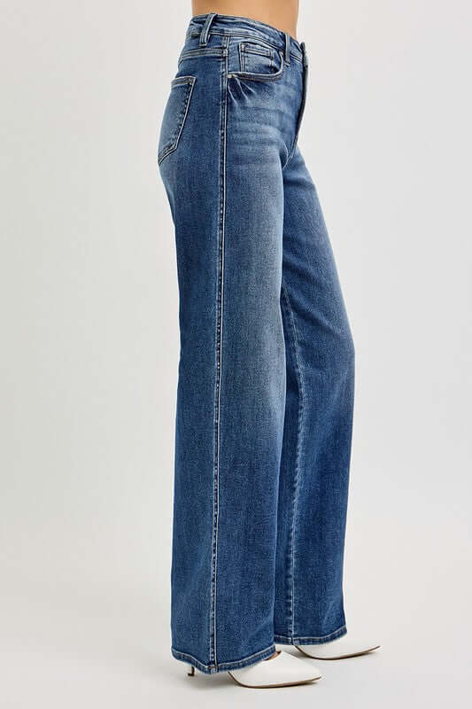 RISEN high-rise tummy control jeans in blue, showcasing a sleek and stylish silhouette from the side.