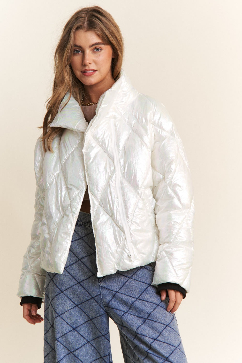 Woman modeling J.NNA quilted mock neck puffer jacket in white with diamond stitch detail, ideal for stylish warmth and comfort.