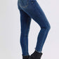 Judy Blue mid-rise waist skinny jeans in dark blue with pockets, styled with black ankle boots. Perfect for any occasion!