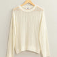 Openwork Ribbed Trim Long Sleeve Knit Top in white on a hanger