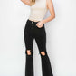 Woman modeling stylish Risen Jeans with distressed raw hem and ripped design, featuring convenient pockets and unique original cuff style.