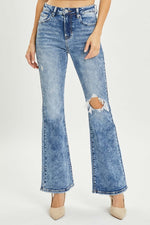 High-rise distressed flare jeans by Risen Jeans featuring a trendy 70s retro vibe, with a flattering fit, vintage-inspired style, and rebellious touch.