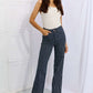 Woman wearing Cassidy Full Size High Waisted Tummy Control Striped Straight Jeans by Judy Blue Jeans.