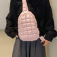 Woman wearing Bella Road Quilted Nylon Crossbody Bag in pink, styled with a black top and gray skirt, showcasing chic fashion.