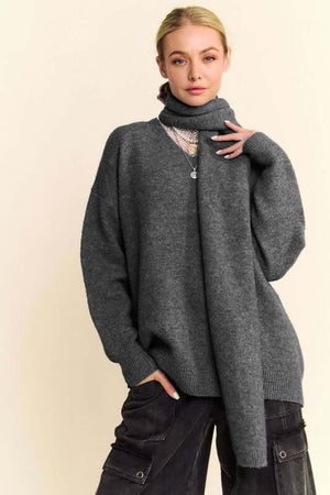 Stylish model in a gray V-neck dropped shoulder sweater with scarf, perfect for cozy, chic outfits.