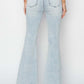 Back view of high rise front patch pocket flare jeans in light blue denim by Risen Jeans, featuring trendy patch pockets.