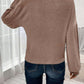 Back view of woman wearing Bella Road Ribbed Round Neck Lantern Sleeve T-Shirt in beige with ribbed texture and lantern sleeves