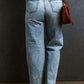 Back view of distressed raw hem straight jeans in petite size, showcasing trendy, playful style with a flattering fit.