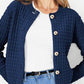 Woman wearing Bella Road blue button-up round neck long sleeve cardigan over white top and jeans.