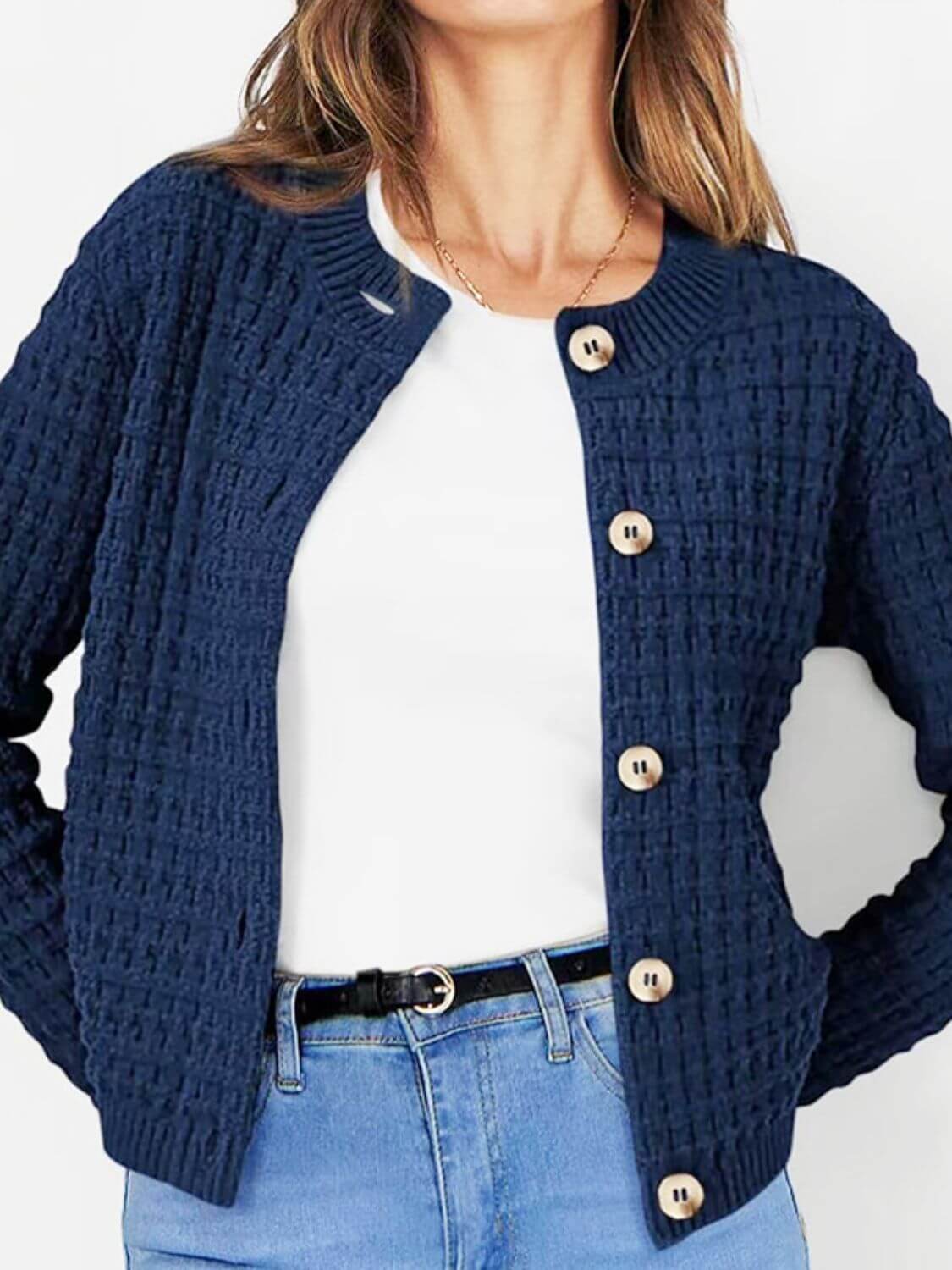 Woman wearing Bella Road blue button-up round neck long sleeve cardigan over white top and jeans.