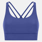 Stylish blue crisscross scoop neck active tank top perfect for workouts and comfortable movement.