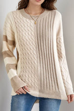 Woman wearing Bella Road cable-knit color block round neck sweater in tan, perfect for cozy and stylish days.