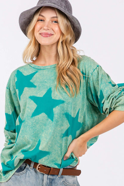 Woman wearing SAGE + FIG Mineral Wash Star Pattern T-Shirt, sporting a trendy star design with a unique washed effect.