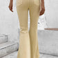 Woman wearing Bella Road Pocketed Raw Hem Flare Jeans in yellow, back view showing slightly stretchy, raw hem flare with pockets