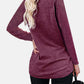 Woman wearing Bella Road round neck long sleeve maroon t-shirt with a pocket, slightly stretchy fabric, and comfortable fit.