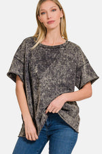 Woman wearing a relaxed fit, rolled round neck short sleeve t-shirt in a soft, breathable fabric, styled with jeans for a casual look.